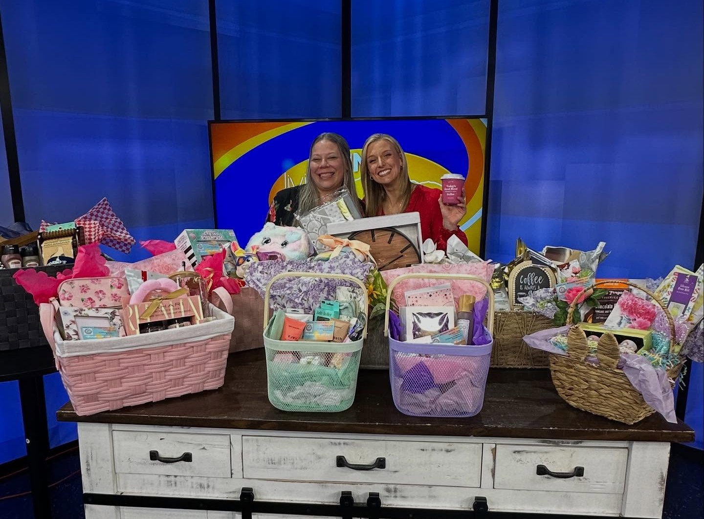 Leah Ward on the Fox 21 Loving Living Local set with a table of her handmade gift baskets